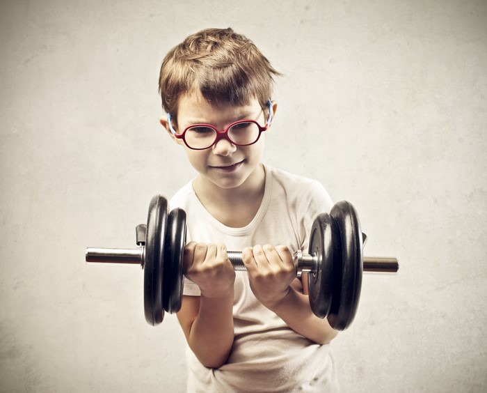 Boy in Glasses Lifting Dumbbells