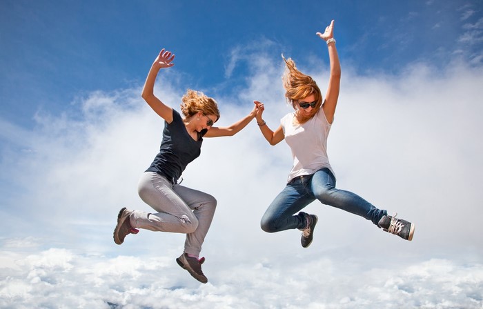 Two women jumping in the sky