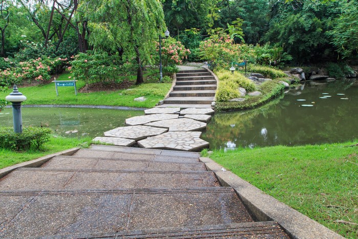Park with pond and stone path in Bangkok, Thailand