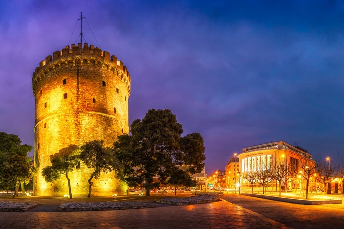 White Tower and building in Thessaloniki, Greece at dusk
