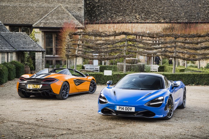 Two McLaren sports cars parked outside a building