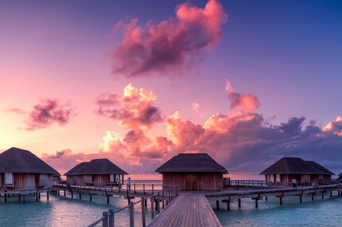 Overwater bungalows at sunset in the Maldives