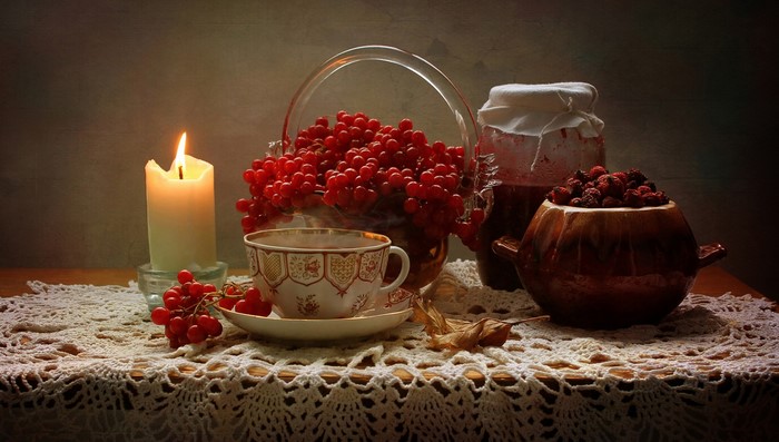 Still-life with candle, tea cup, and berries