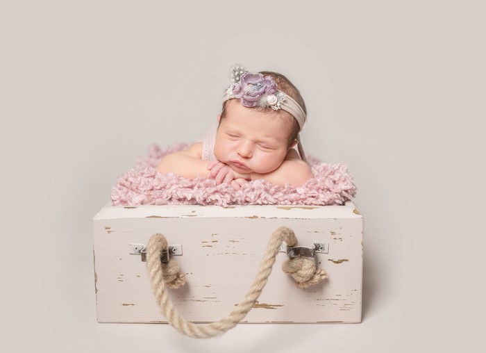 Newborn baby sleeping in a box