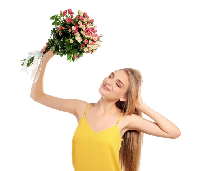 Blonde girl holding a bouquet of roses