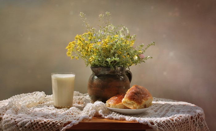Still life with milk, buns, and flowers