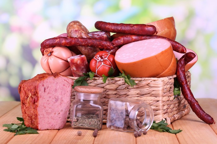 Assortment of meat products and spices in a wicker basket