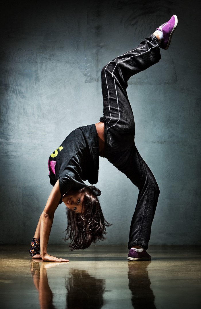 Woman performing a handstand bridge dance move