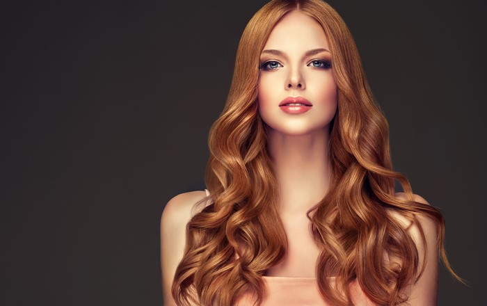 Woman with long wavy auburn hair