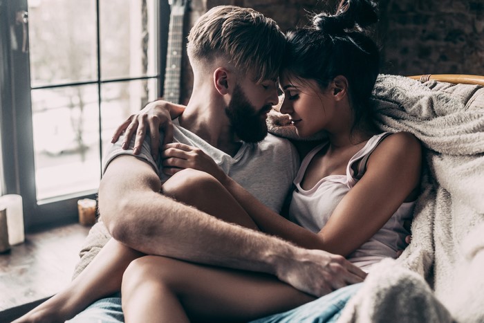 Couple embracing under a blanket