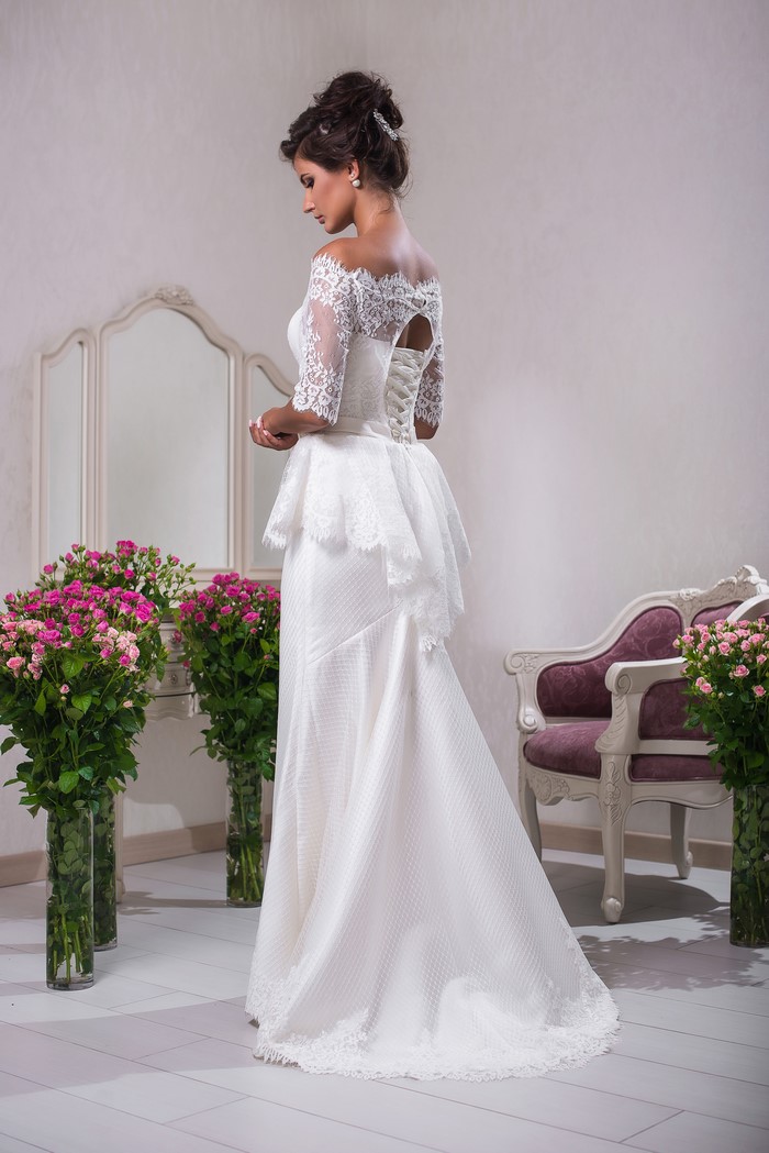 Bride in a white wedding dress with lace sleeves
