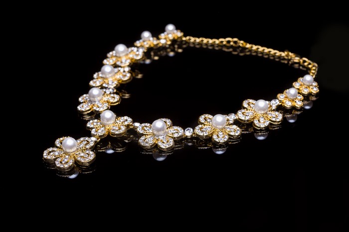 4K necklace with pearls and stones on black background