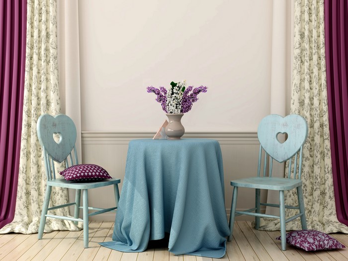 Table with heart chairs and floral curtains