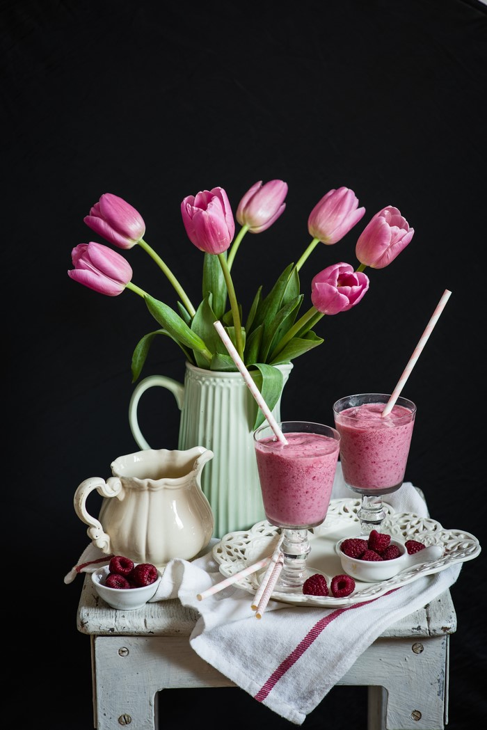 Still-life with pink tulips and raspberry smoothies