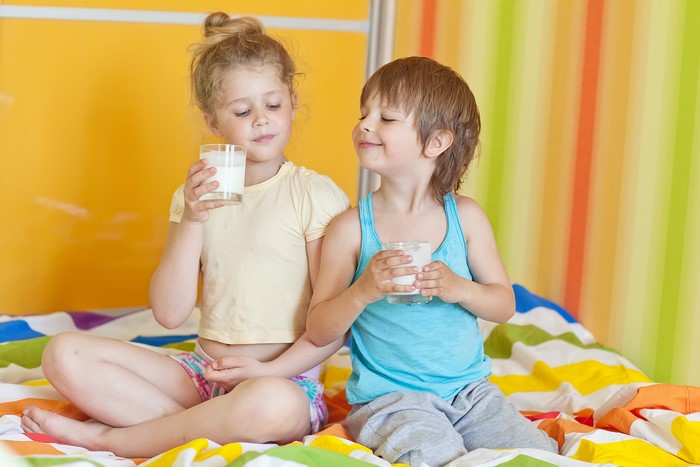 Two children drinking milk
