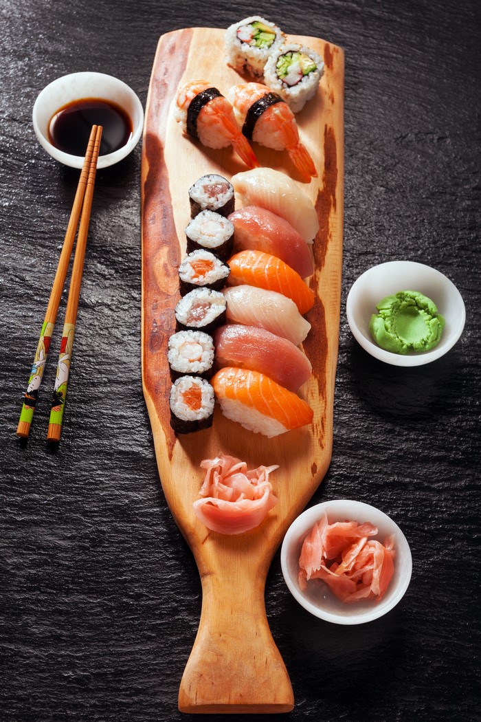 Sushi platter with soy sauce, wasabi, and pickled ginger