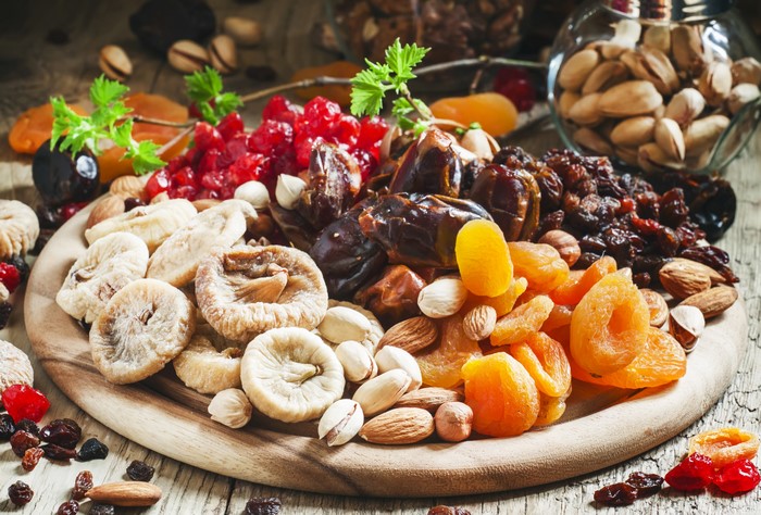 Assortment of Dried Fruits and Nuts on a Wooden Board