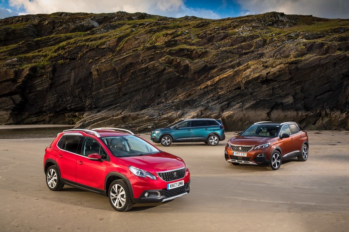 Three Peugeot SUVs on a Beach