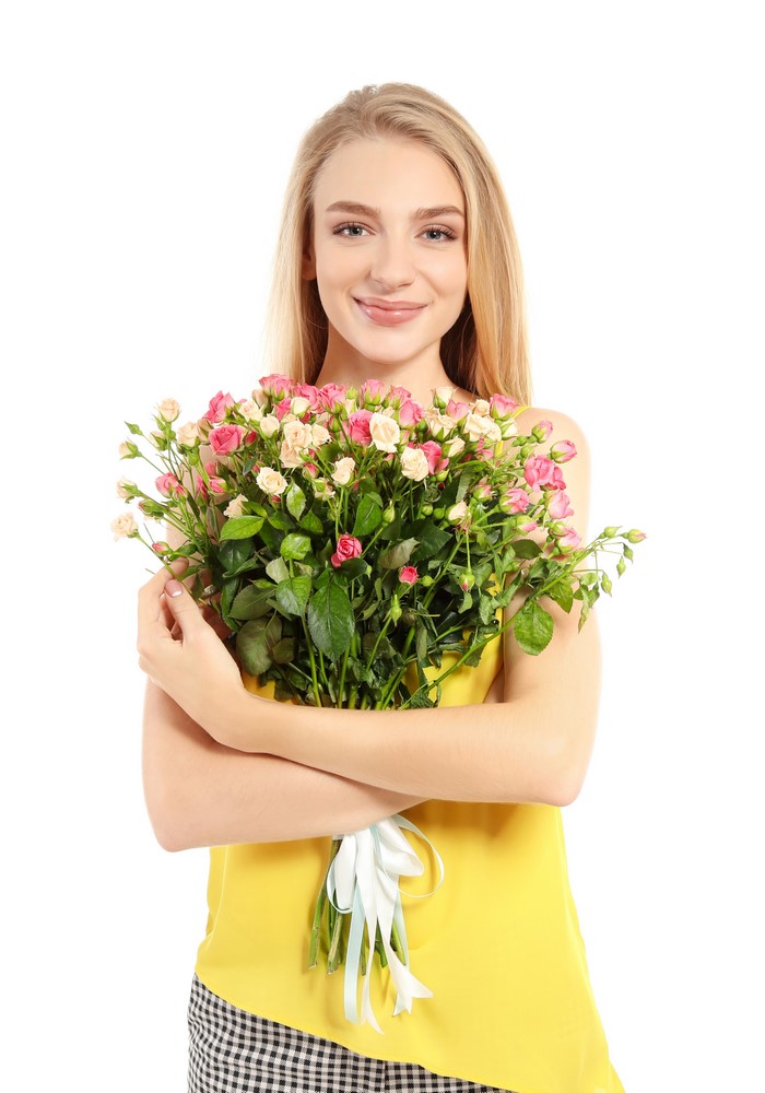 Blonde girl holding a bouquet of roses