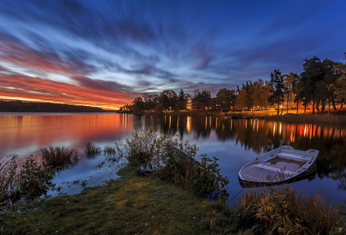 Boat on lake at sunset with colorful sky