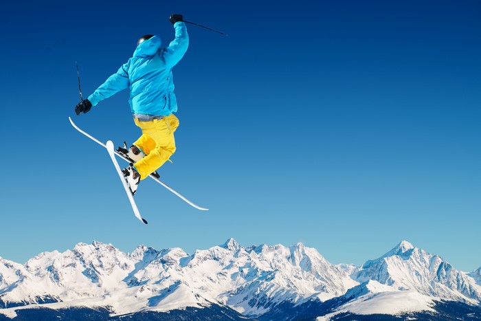 Skiing jump over snowy mountains
