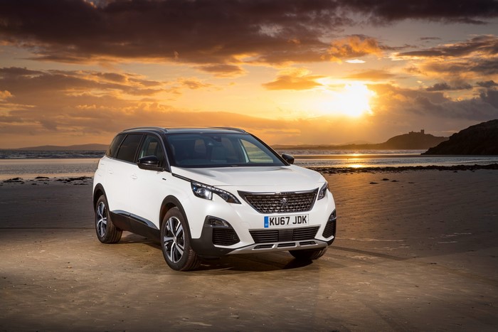 White Peugeot 5008 GT Line on a beach at sunset