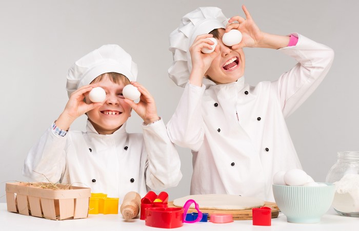 Two Boys in Chef Uniforms Playing with Eggs