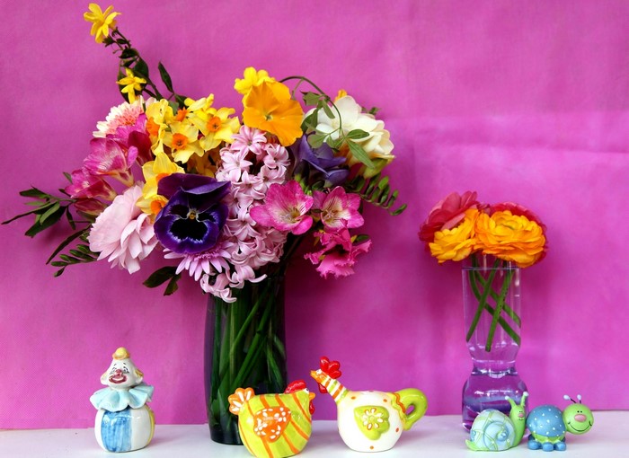 Still-life with bouquets of flowers and decorative figurines