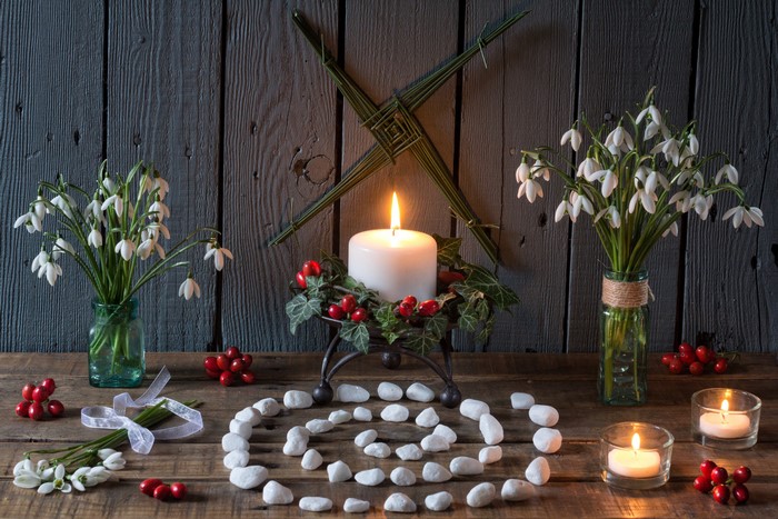 Still-life with snowdrops, candles, and stones