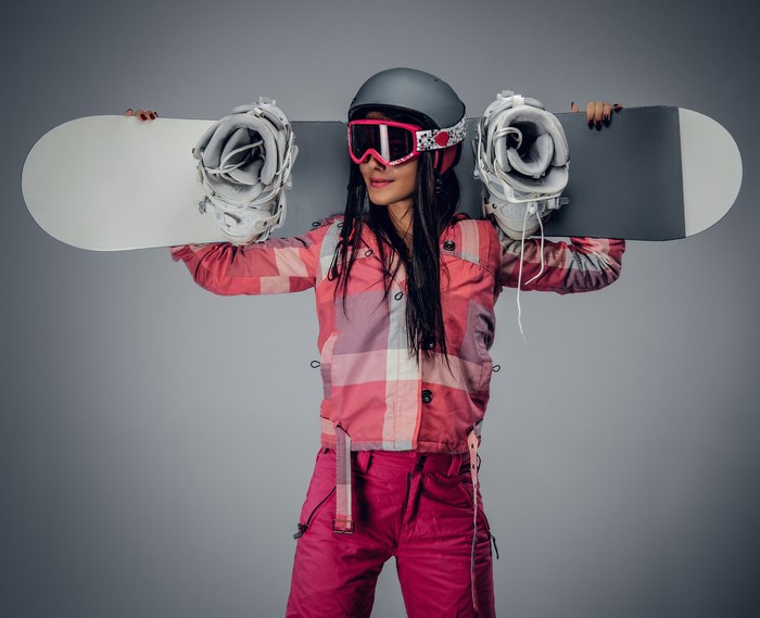 Woman in Snowboarding Gear Holding Snowboard