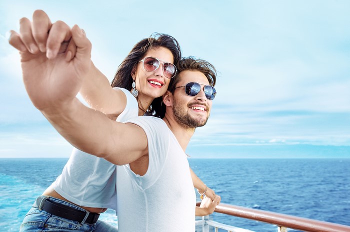 Couple taking a selfie on a cruise ship deck
