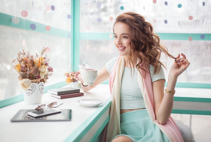 Brown haired woman holding a cup