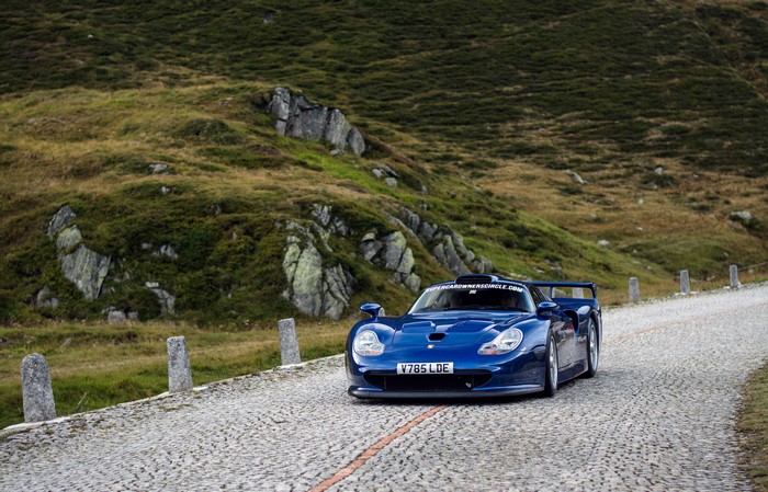 Blue Porsche 911 on a mountain road