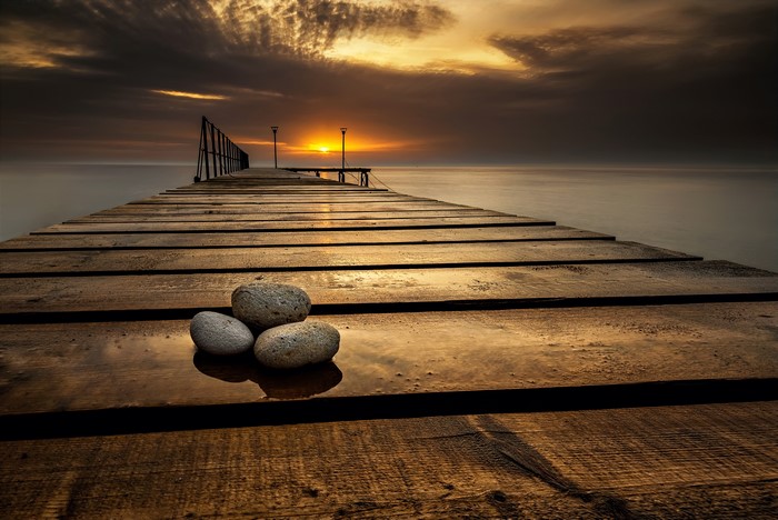 Wooden pier with stones at sunset in Varna, Bulgaria