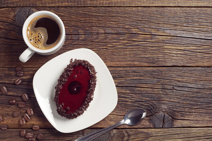 Coffee cup and cake on wooden table