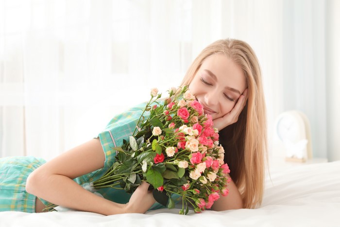 Blonde girl with bouquet of roses