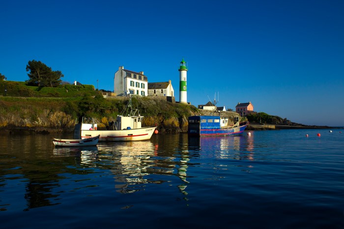 Boats and lighthouse in Doelan, Brittany, France