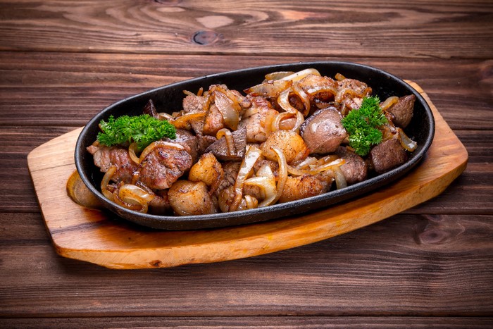 Grilled Meat and Onions on a Hot Plate