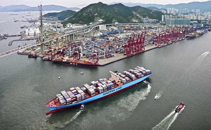 Maersk Line container ship at a busy port with cranes