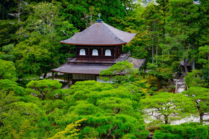 Ginkaku-ji Temple surrounded by lush green trees in Kyoto, Japan