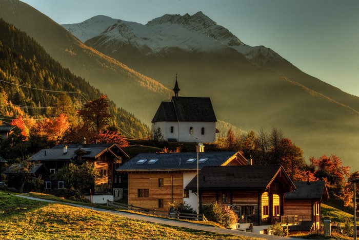 Village with church and mountains in Switzerland