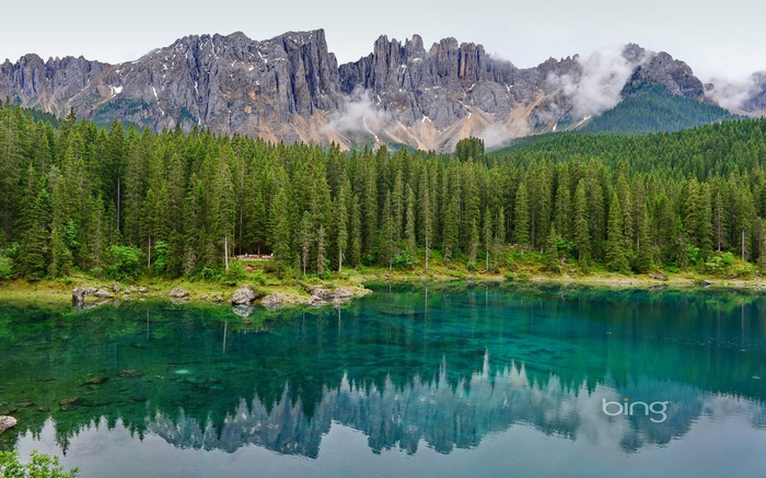 Lake with forest and mountains reflection