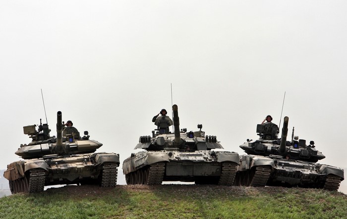 Three Russian tanks with soldiers saluting