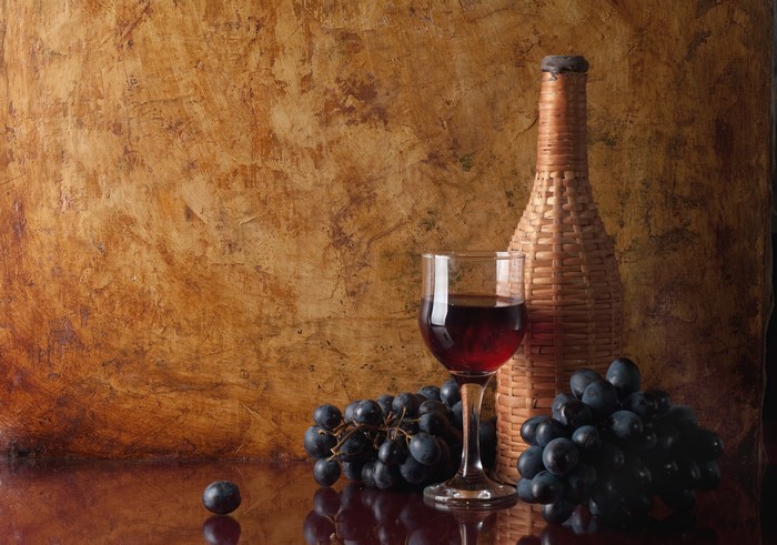 Wine bottle, glass, and grapes still life