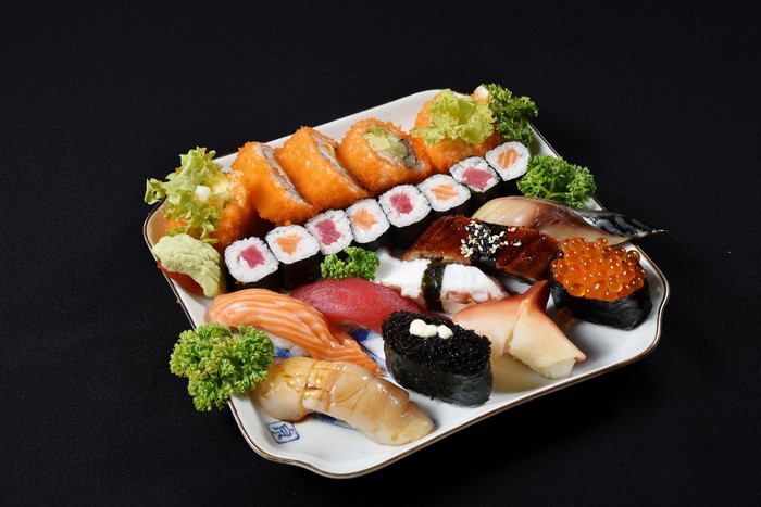 Sushi platter with various types of sushi and rolls