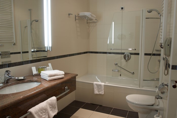 Modern hotel bathroom with bathtub and sink