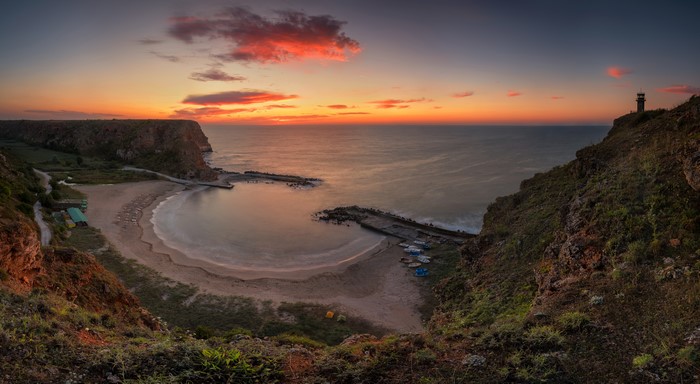 Sunrise over a bay with a lighthouse in Bulgaria