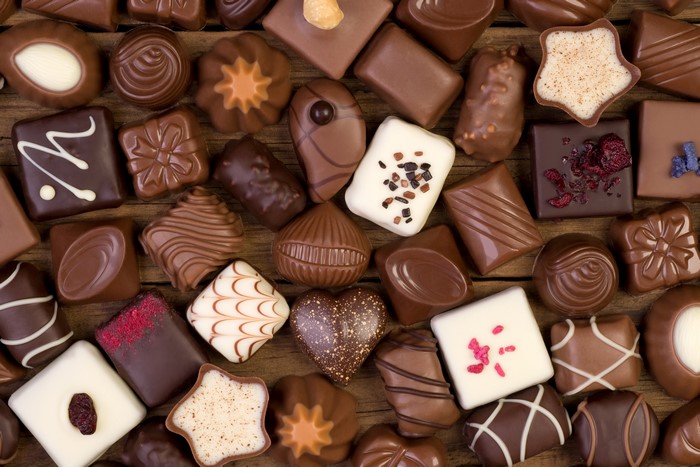 Assortment of assorted chocolates on a wooden surface