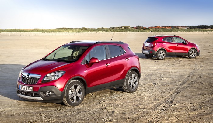 Two red Opel Mokka cars on a sandy beach