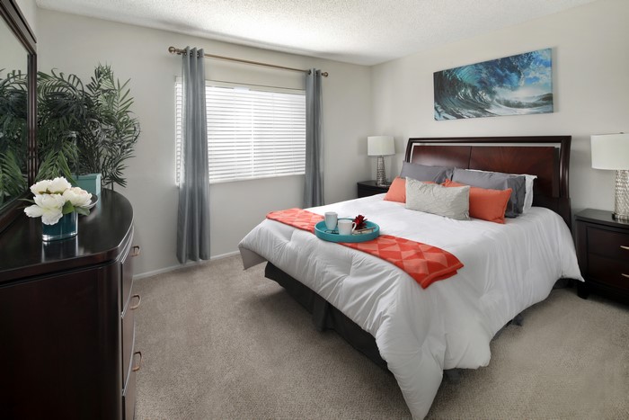 Bedroom with a bed, dresser, and artwork